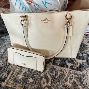 Women’s cream coach hand bag with matching wallet.